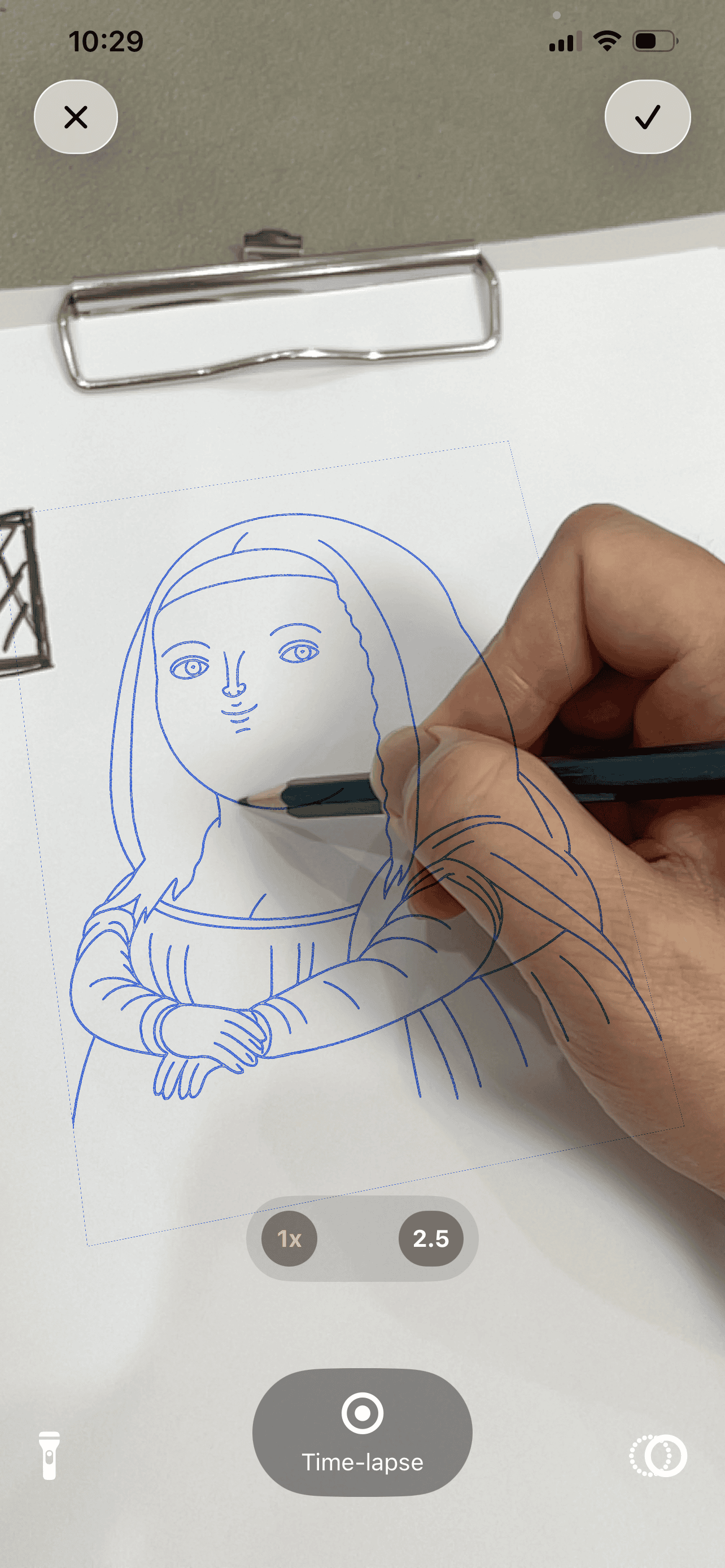 sketch.AR in use: a hand tracing the blue AR outline of the Mona Lisa onto paper, with zoom and time-lapse controls on screen