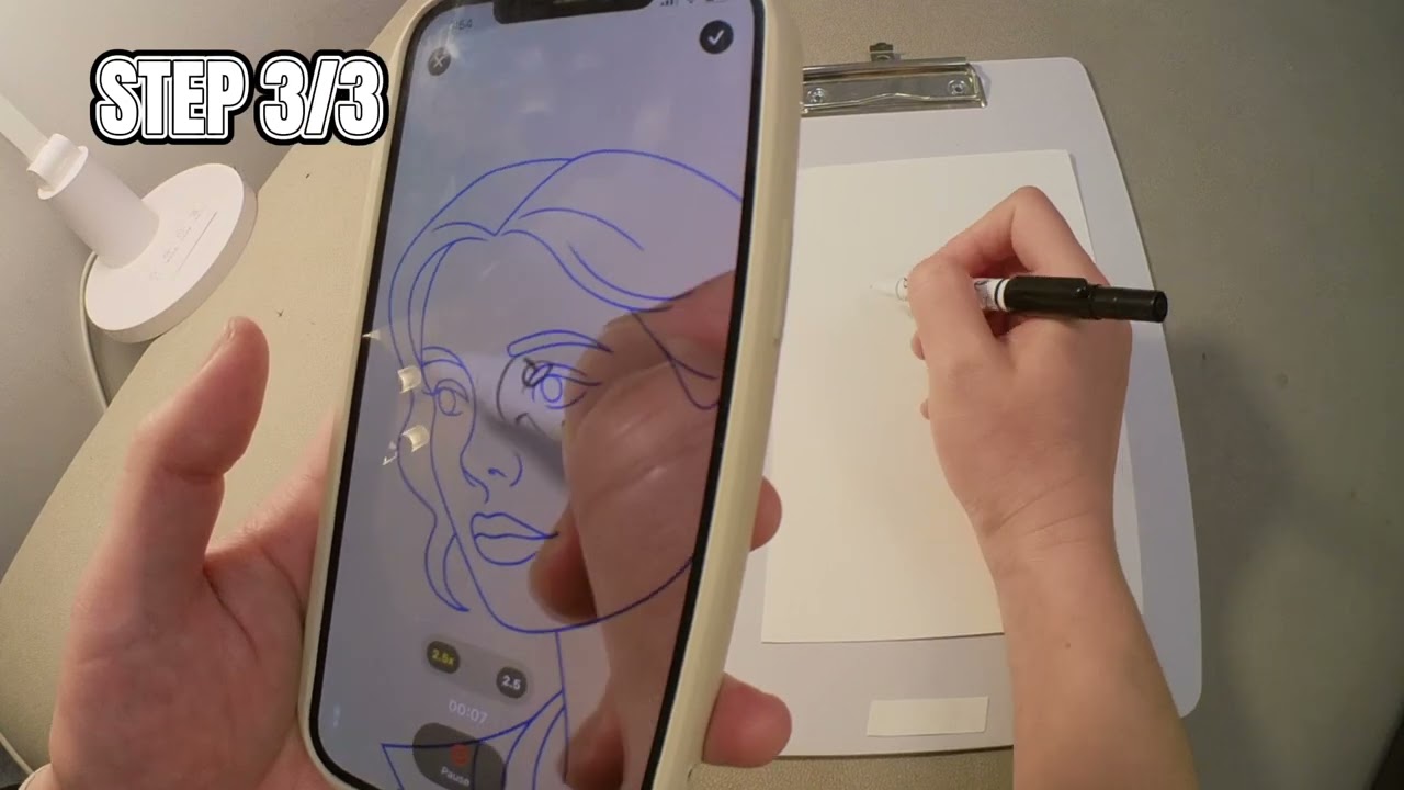 Still from the sketch.AR demo video: an iPhone showing a blue AR portrait outline while a hand draws on paper beside it